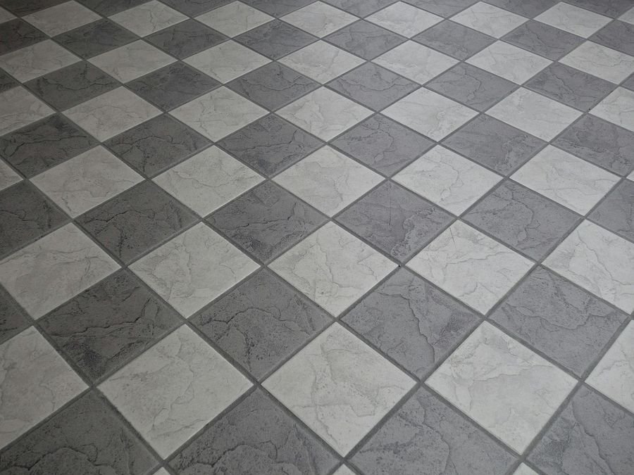 Pose de carrelage grand format sur un sol intérieur